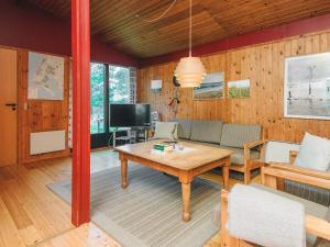 a living room with a table and a tv at Luxury Retreat in Blavand - By Traum Ferienwohnungen in Blåvand +32 photos