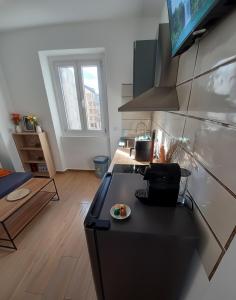 a kitchen with a black stove top in a room at Cozy apartment near downtown in Turin
