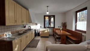 a kitchen with a sink and a table in it at Valtellina home in Grosotto