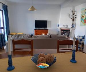 a living room with a table with two candles and a couch at Quiaios Beach House in Quiaios