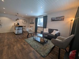 a living room with a couch and a table at Guesthouse Olivier in Hammarstrand
