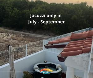 a jovalim only in july september on a balcony with at Quiaios Beach House in Quiaios