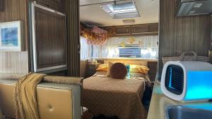 a bedroom with a bed and a tv in it at Australian Retro Beach stay in Rye