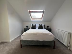 a bedroom with a large bed with a skylight at The Bluebird B&B III in Central Station