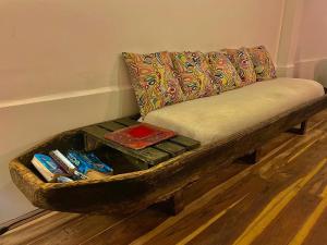 a wooden bench with a pillow on top of it at Casa Kai in Palomino