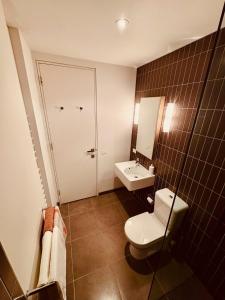 a bathroom with a toilet and a sink at The Retreat at St Andrews Beach Golf Course in Fingal