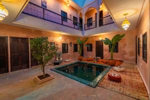 a house with a pool in the middle of a room at Riad Lalla Fatima Marrakech in Marrakesh