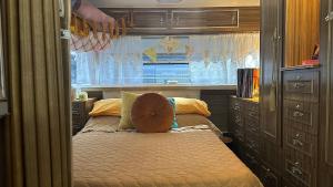 a bedroom with a bed with a pillow on it at Australian Retro Beach stay in Rye