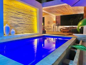 a swimming pool in a house with a living room at Casa Kai in Palomino