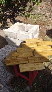 a wooden picnic table sitting on the ground at Casa de Boneca perto da praia in Imbituba +3 photos