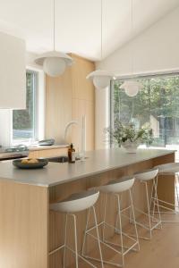 a kitchen with a island with bar stools at Maison Solus - Mont Tremblant in Lac-Superieur