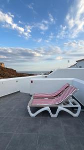 a bench sitting on top of a roof at Vidamar in Abades