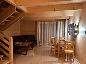 a living room with a table and a dining room at Domki Michelle in Wisła +17 photos