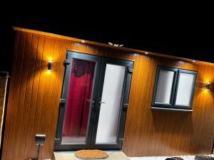 a building with two doors and a red curtain at Mordern Ensuite room in Bedford