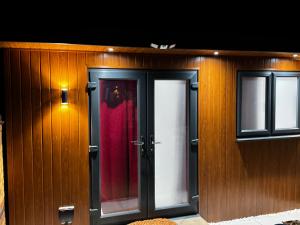 a building with two doors and a red curtain at Mordern Ensuite room in Bedford