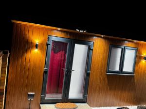 a building with a door and two windows at Mordern Ensuite room in Bedford