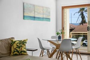 ein Wohnzimmer mit einer Couch und einem Tisch und Stühlen in der Unterkunft Beachside Nook at Warilla in Lake Illawarra + 5 Fotos