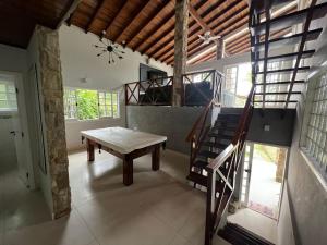 a living room with a staircase and a bench at Casa Park Imperial 