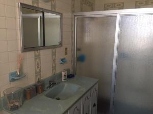 a bathroom with a sink and a shower with a mirror at Casa Dos Hermanas in Guanajuato +34 photos
