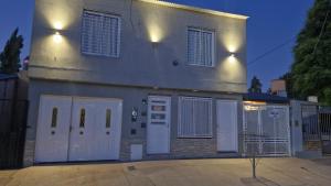 a large house with white doors and gates at Dalia Pampa in RSA