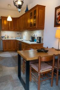 a kitchen with wooden cabinets and a wooden table at Billy's Place in Aegina Town
