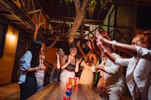 a bride dances in front of a crowd of people at Bamboo Búzios Hostel in Búzios