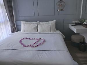 Ένα ή περισσότερα κρεβάτια σε δωμάτιο στο Palmyrah Surin Beach Residence +13 φωτογραφίες