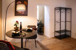 a living room with a table and a lamp at Arden Stay Apartments in Duisburg