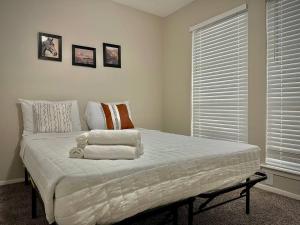 a bedroom with a bed with two towels on it at KINGbed A plus location A plus for workers LongStayDiscount in Sherman