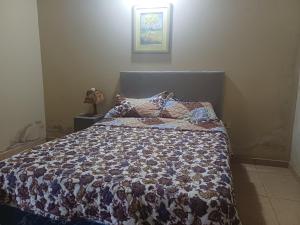 a bedroom with a bed with a quilt on it at De vuelta a casa in Zarate Isla