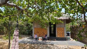 a small house with two chairs and a table at Plancton House Atins in Atins +10 photos