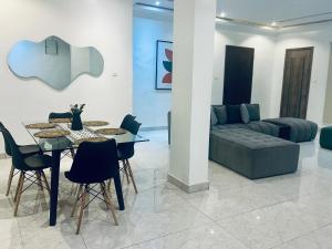a living room with a table and a couch at Golden apartment in Lagos