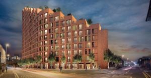 a tall red brick building on a city street at Skyline Garden Suite - City Centre in Beeston Hill