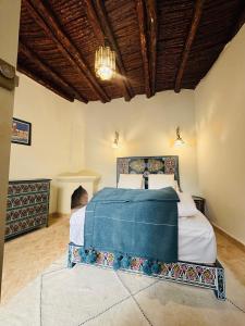a bedroom with a bed and a chandelier at Riad Sultanes in Essaouira