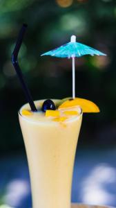 a drink with an umbrella on top of it at Sacaan Tropical Breeze Resort in Sogod