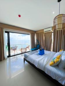 a bedroom with a bed with a view of the ocean at Sacaan Tropical Breeze Resort in Sogod