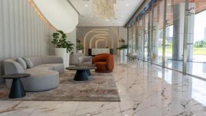 a lobby with a couch and chairs and tables at Modern 1-Bedroom with Park Views in Panama City in Panama City +15 photos