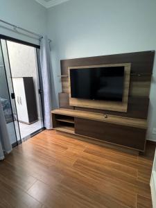 a living room with a flat screen tv on a wall at Casa Encanto in Franca