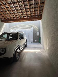a white suv parked in a garage at Casa Encanto in Franca