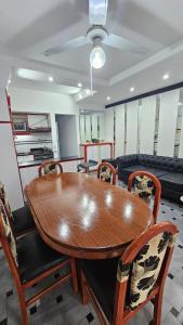 a dining room with a wooden table and chairs at Allá en el sur Canning in Ezeiza