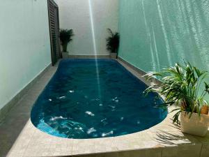 a large swimming pool with blue water in a building at Spectacular Private House in Playa del Carmen