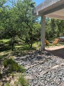 a stone walkway in front of a house at Cabaña El Quebrachal in Valle Hermoso