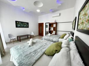 a bedroom with two beds and a couch at Spectacular Private House in Playa del Carmen +68 photos