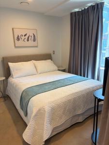 a bedroom with a large bed and a window at Central City Prime-next to SKY in Auckland +4 photos
