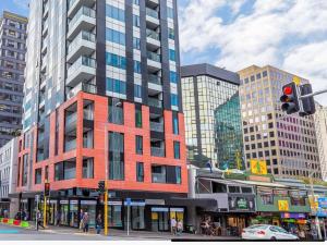 a tall building on a city street with a traffic light at Central City Prime-next to SKY in Auckland