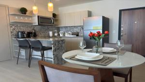 a kitchen with a dining table and a refrigerator at Modern 1-BR with Park & Ocean Vistas in Panama City in Panama City