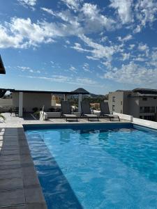 a swimming pool on the roof of a building at Hello Sunshine! in Cabo San Lucas