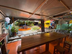 a dining room with a wooden table and a mural at Casona Don Juan Hostel in San Gil