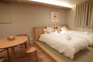 Postel nebo postele na pokoji v ubytování SOULEIADO Shinosaka