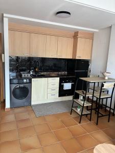 a kitchen with a stove and a table with chairs at Spa and wellness holiday in Villanueva de Río Segura +33 photos